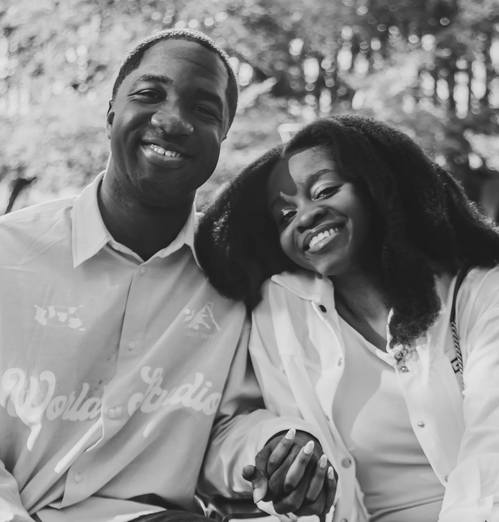 Jeremy and Afriyie smiling cheek to cheek, in black and white