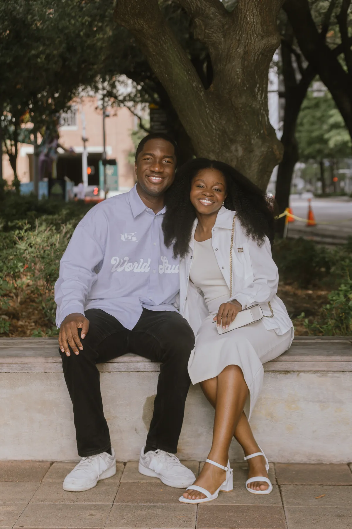Jeremy and Afriyie sitting together under the trees