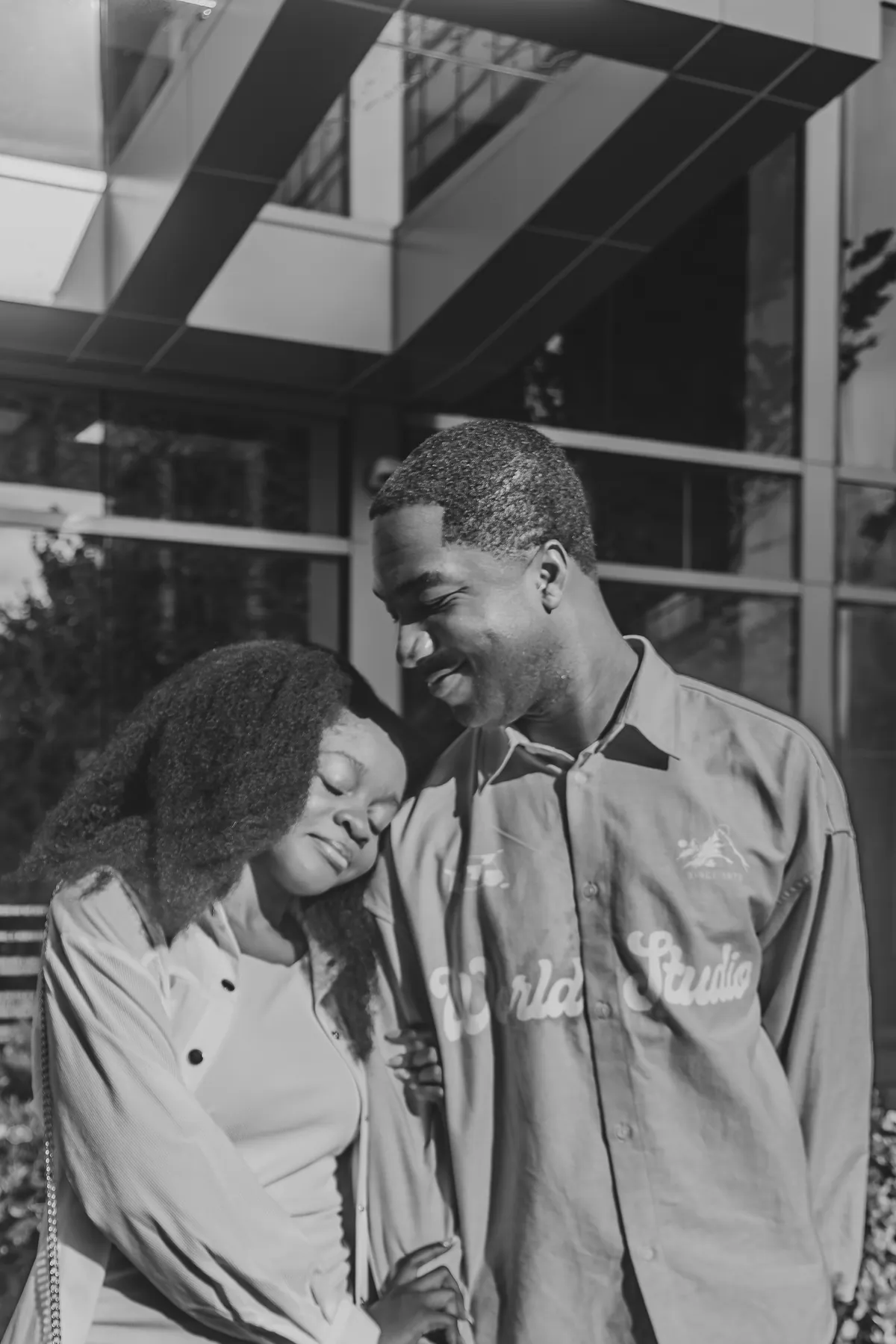Afriyie resting her head on Jeremy, in black and white