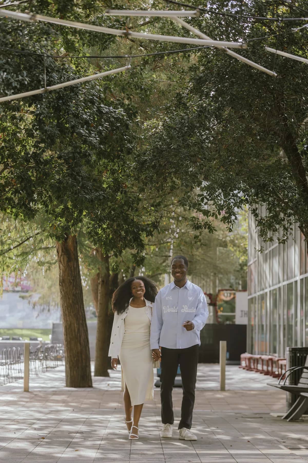 Jeremy and Afriyie walking along a tree-lined path